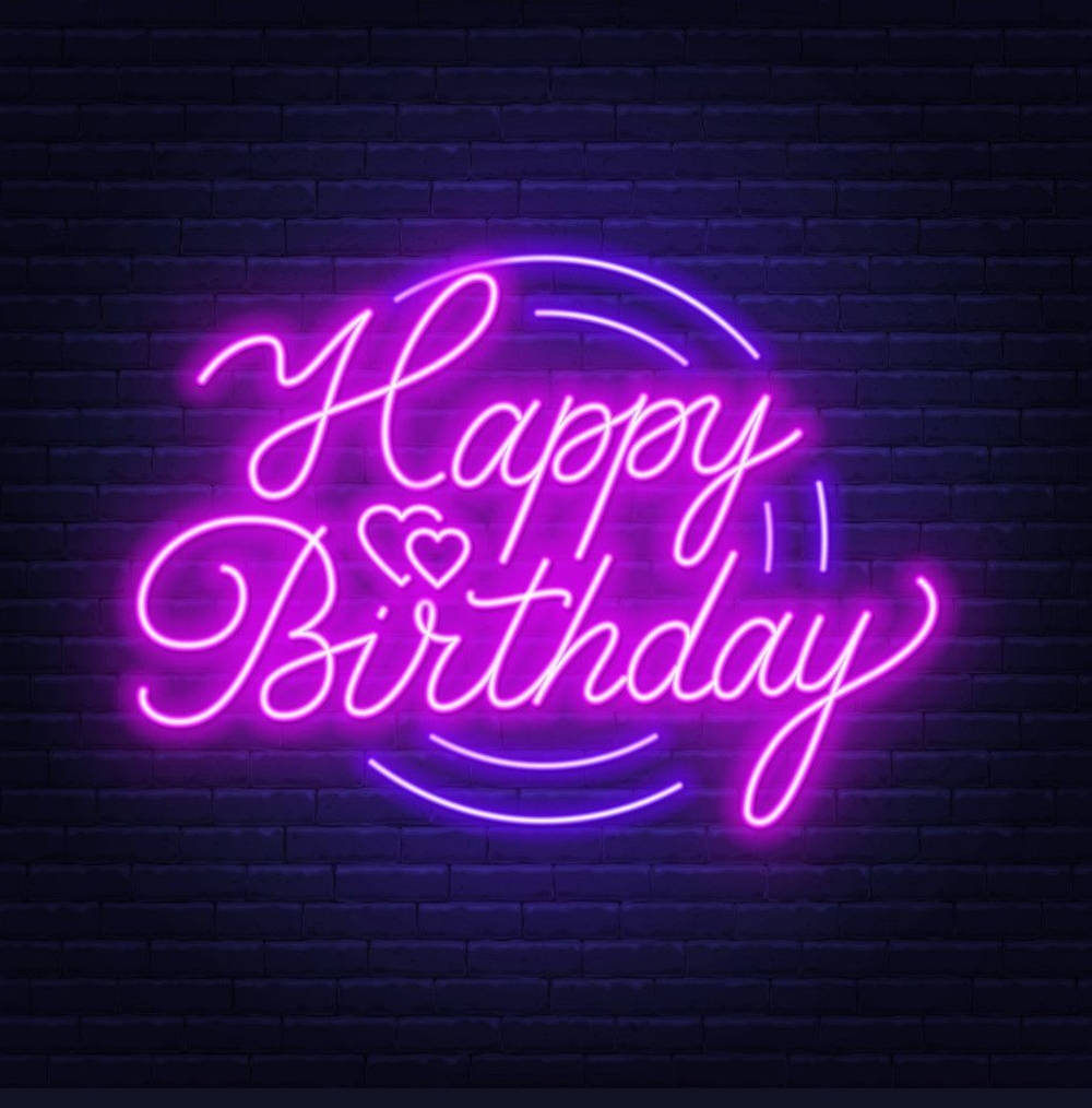 霓虹燈牌在夜間的磚牆上顯示 Happy Birthday 並帶有心形。 — 生日快樂 GIF 壁紙