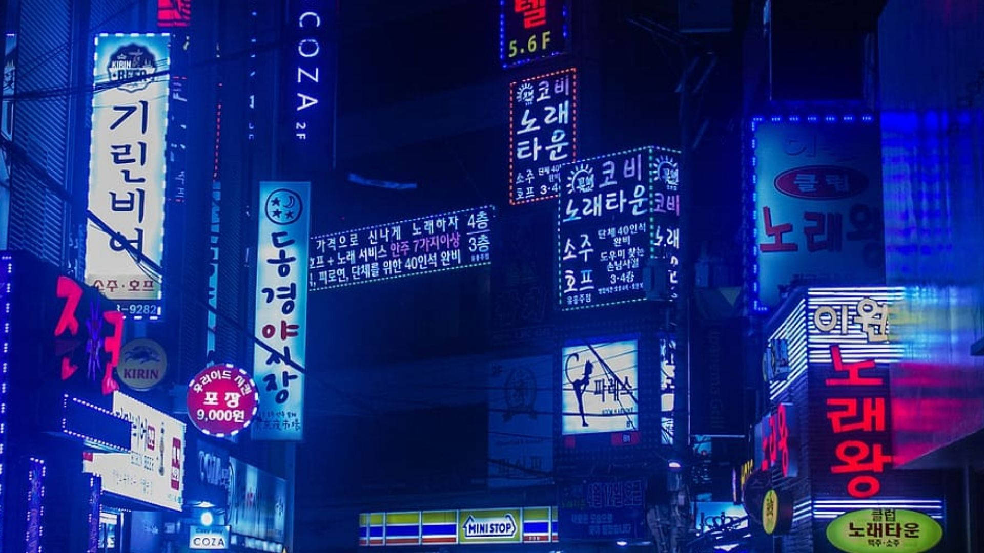 霓虹藍動畫 桌布 壁紙 — 鮮豔的韓文霓虹招牌在黑暗的城市夜空下，於繁華的街道上閃耀。