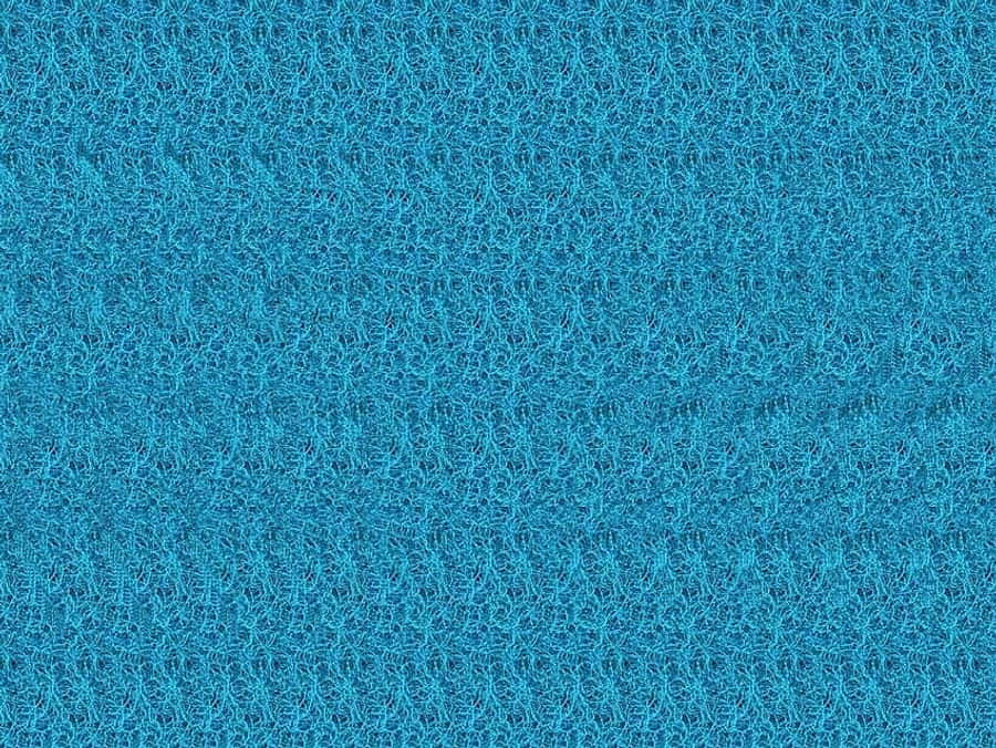 Magic Eye 桌布 壁紙 — 鮮豔藍色紋理布料的特寫，具有一致的編織圖案和柔軟纖維。