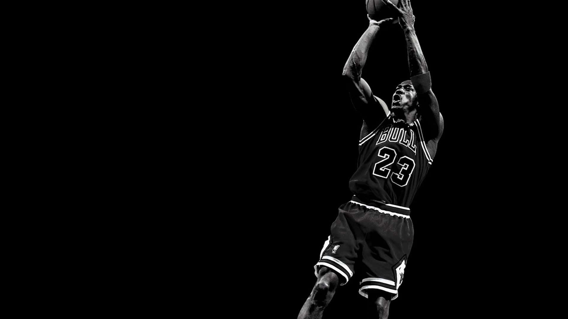 Jordan 桌布 壁紙 — 麥可喬丹在半空中灌籃籃球的黑白剪影，背景為純黑色。