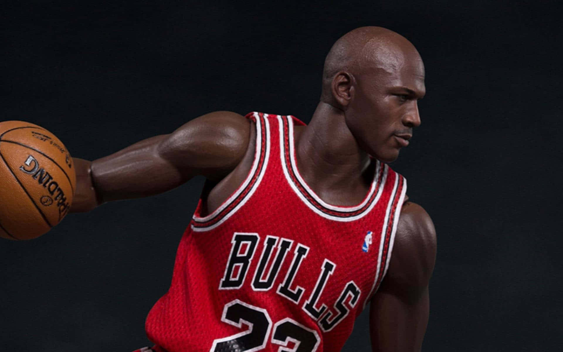 Cartoon NBA Players 桌布 壁紙 — 麥可喬丹身穿紅色公牛隊球衣，在深色背景下專注地運球。