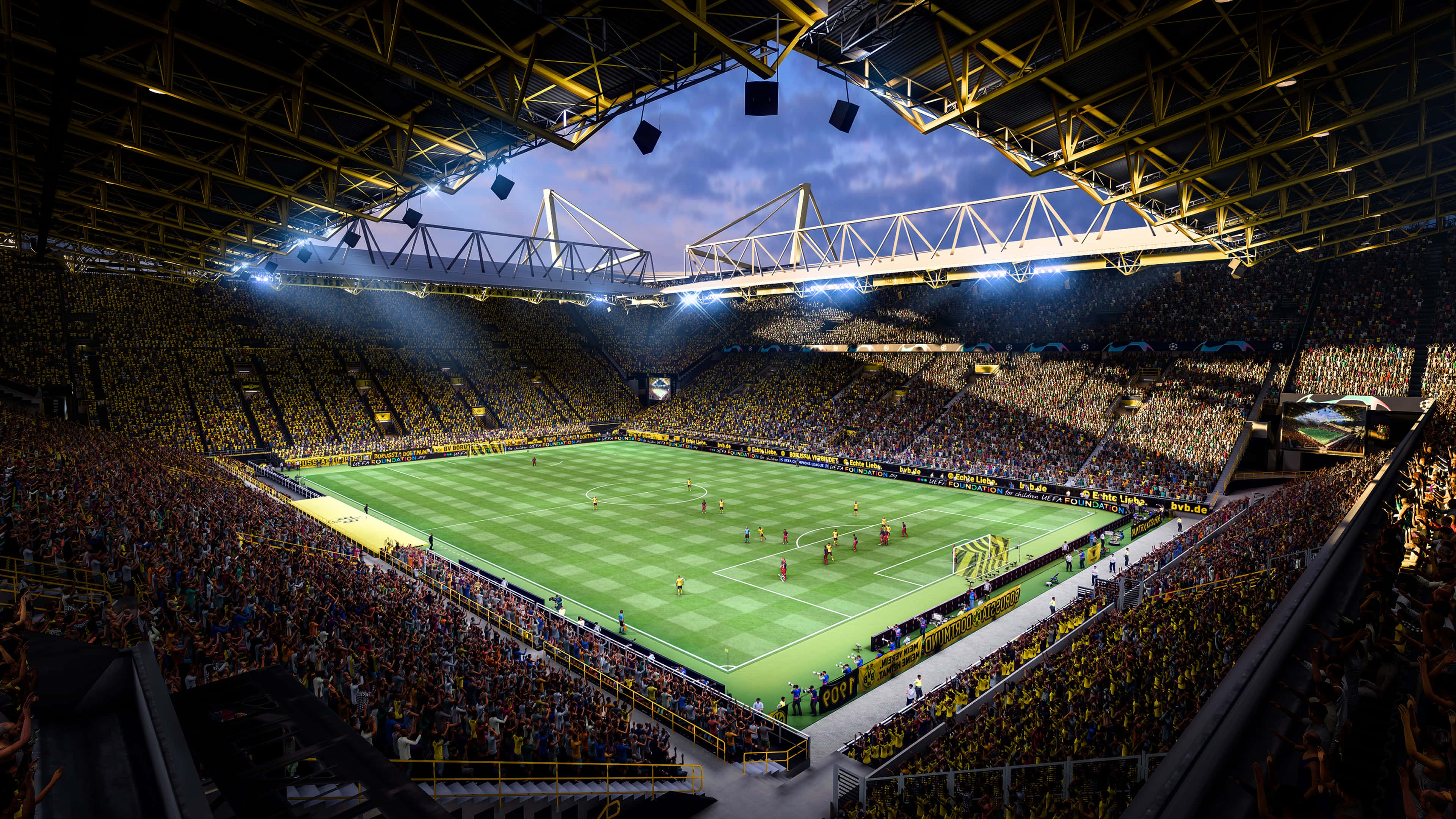 Fifa 22 桌布 壁紙 — 黃昏時分，一個座無虛席的足球場，充滿活力的黃色球迷和明亮的泛光燈照亮了綠色球場。