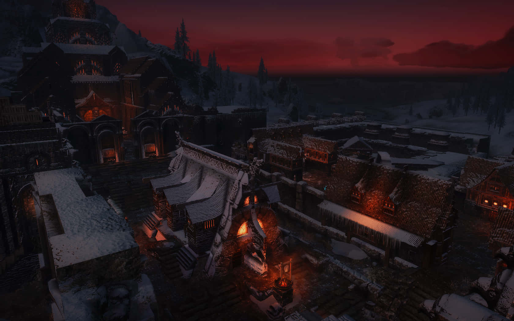 Skyrim Windhelm 桌布 壁紙 — 黃昏時分，一個被雪覆蓋的中世紀村莊，溫暖發光的窗戶映襯著火紅的天空。