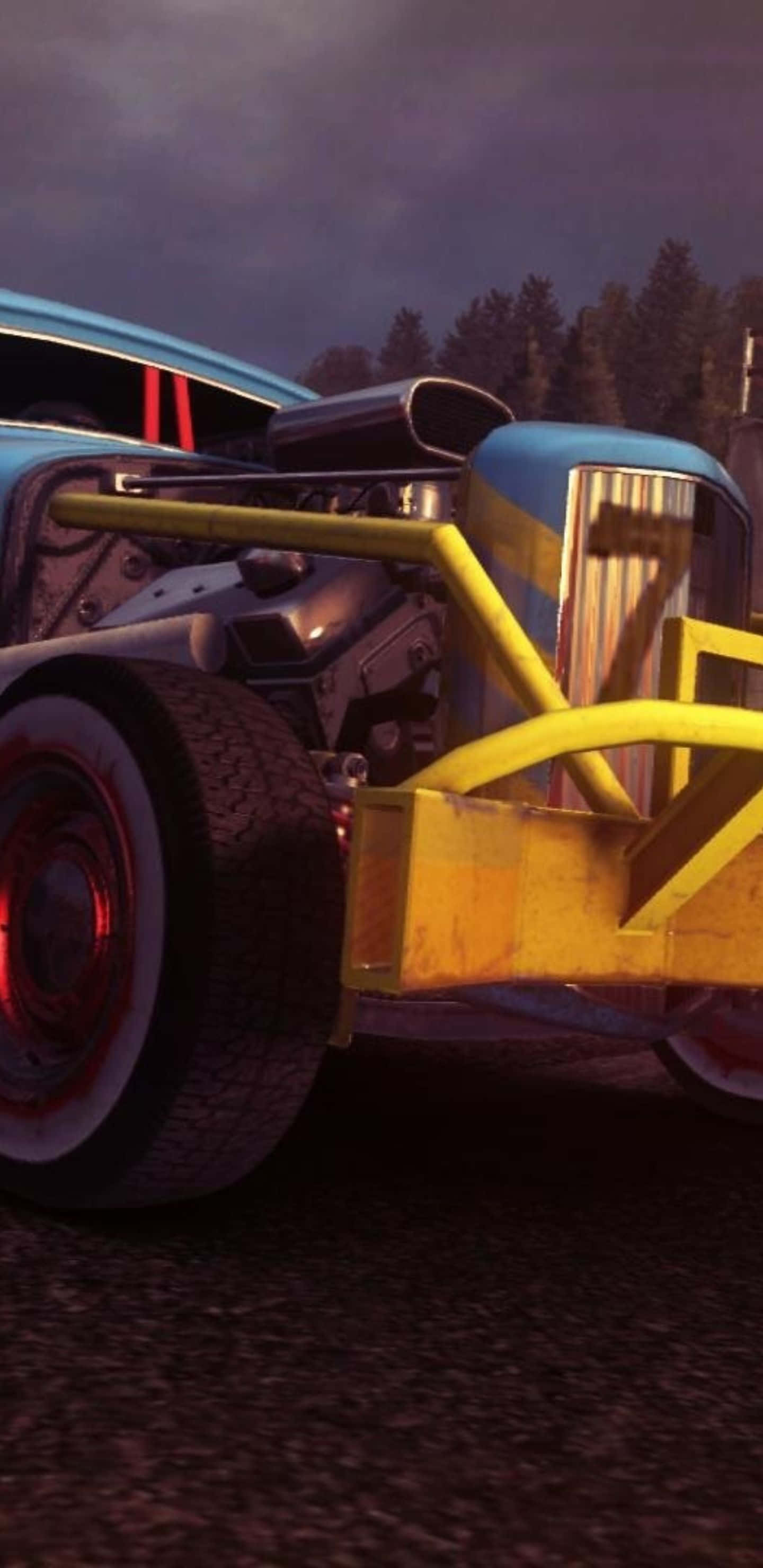 Monster Truck 桌布 壁紙 — 黃昏時分，一輛訂製藍黃色熱棒車的低角度拍攝，引擎外露，車輪發出紅光。