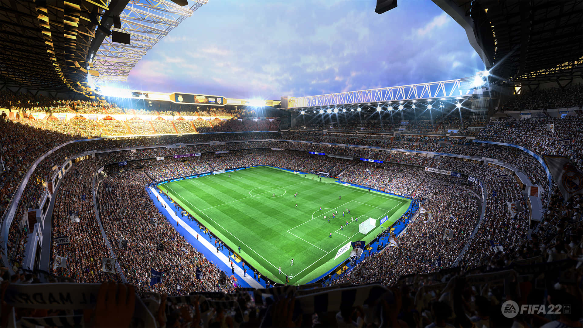 Fifa 22 桌布 壁紙 — 黃昏時分，從空中俯瞰一個擠滿人的足球場，明亮的泛光燈照亮了綠茵場地和熱情歡呼的球迷。