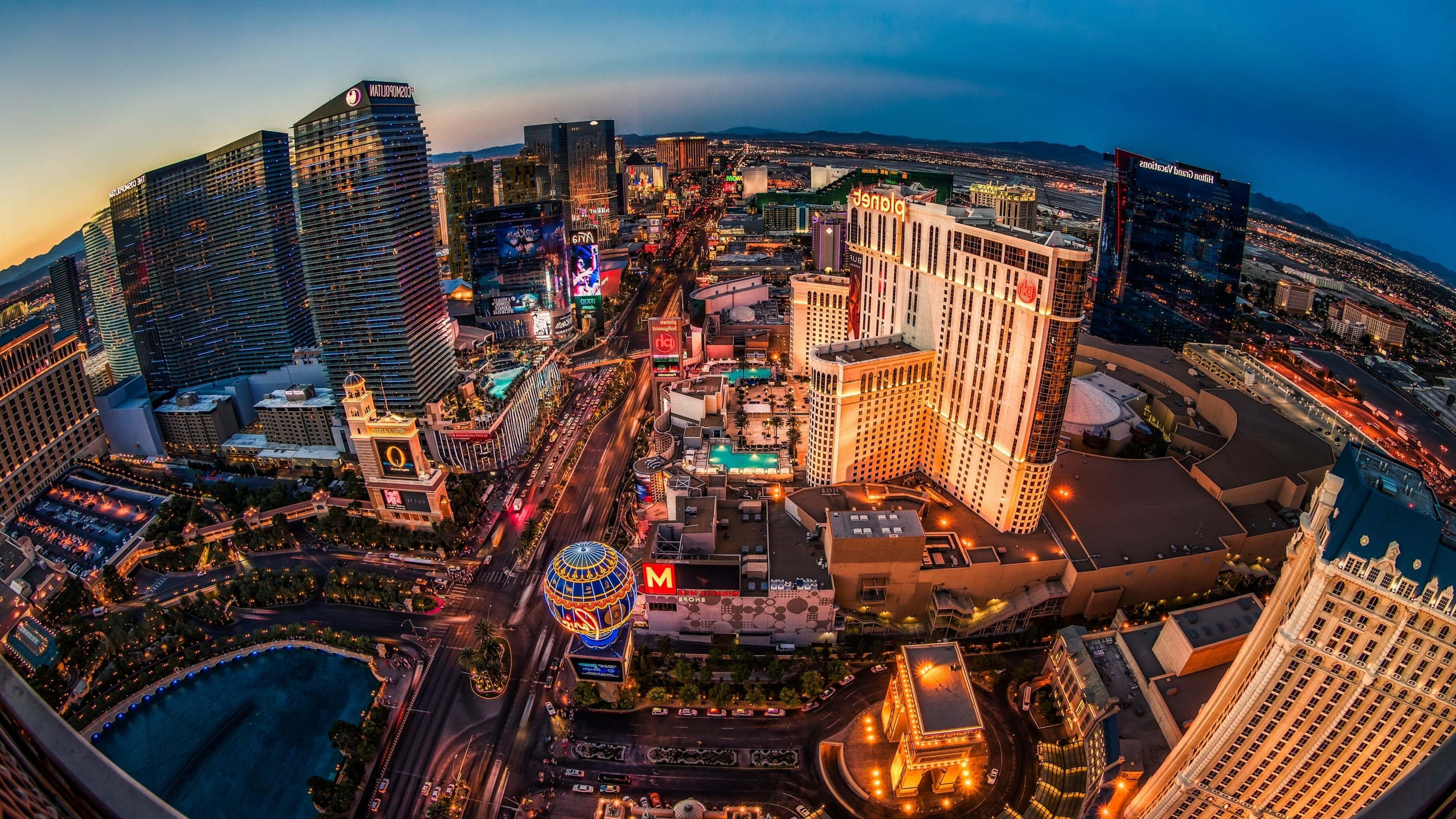 4K Las Vegas 桌布 壁紙 — 黃昏時分拉斯維加斯的鳥瞰圖，閃爍的賭場塔樓和下方繁忙的街道。