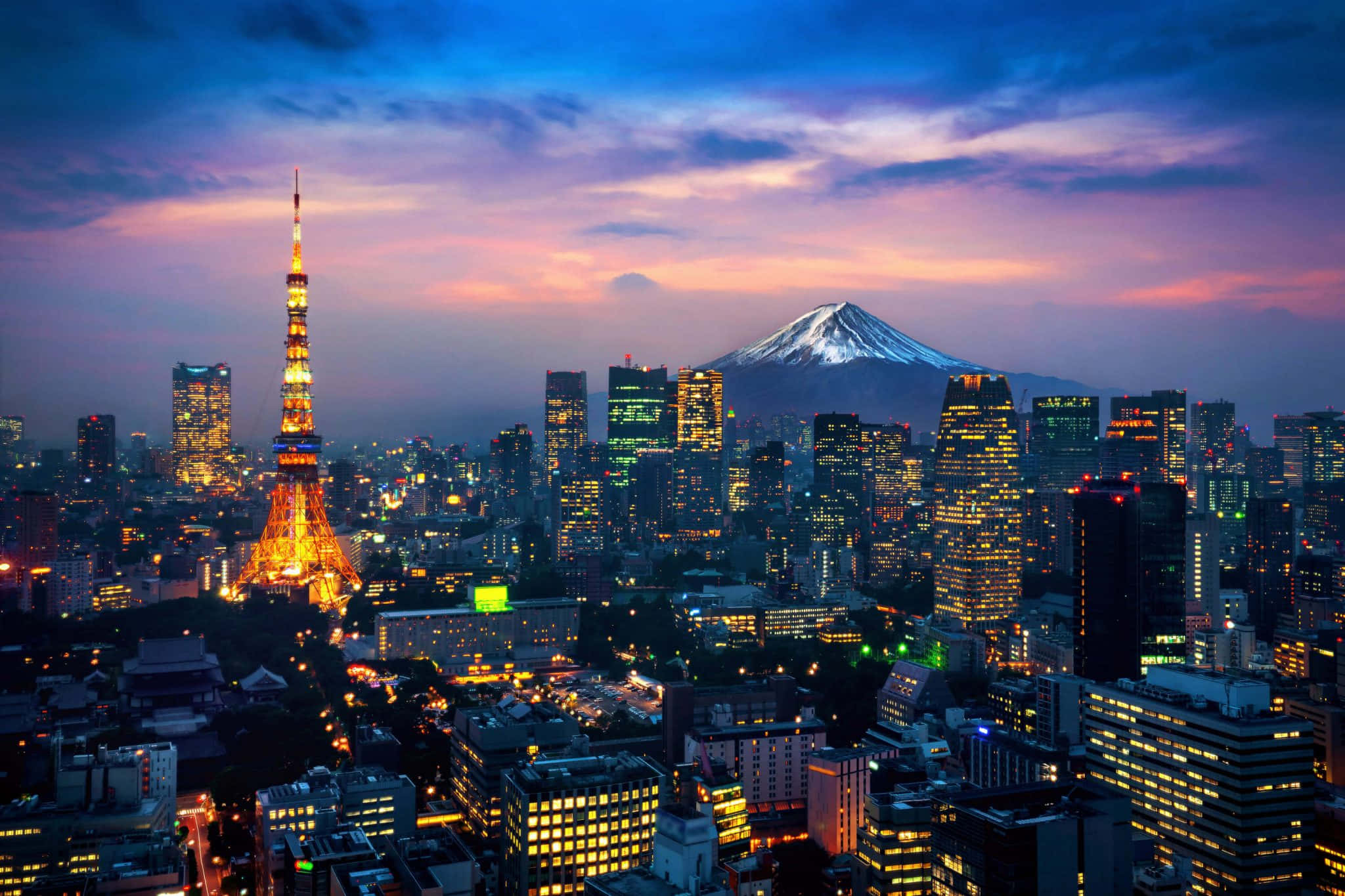 東京 桌布 壁紙 — 黃昏時分的東京天際線，燈火通明的東京塔和積雪的富士山在紫色和橙色的天空下閃耀。
