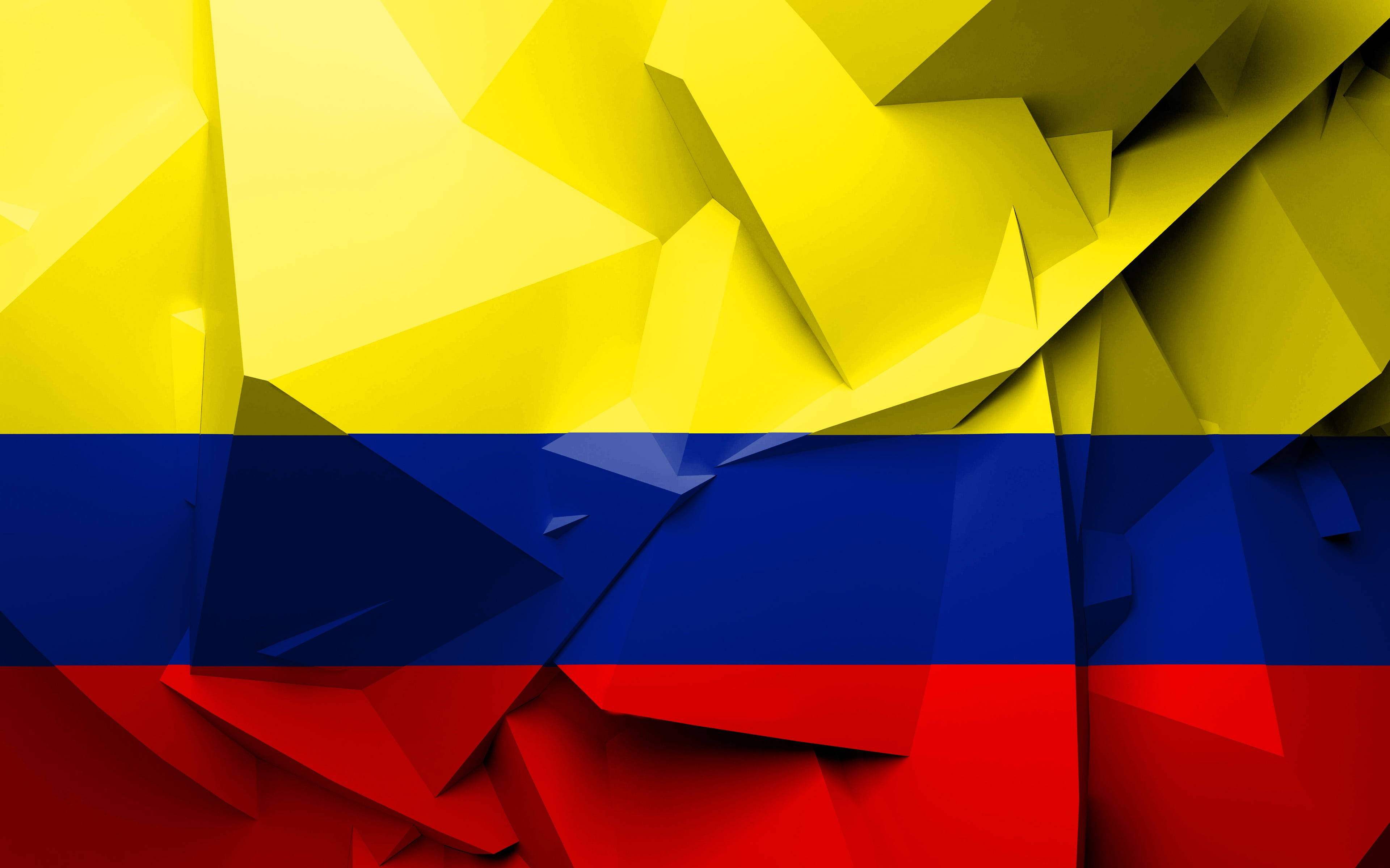 Colombia Flag 桌布 壁紙 — 黃色、藍色和紅色的鮮豔幾何切面形成風格化的哥倫比亞國旗，具有銳利的角狀摺疊和大膽的色彩區塊。
