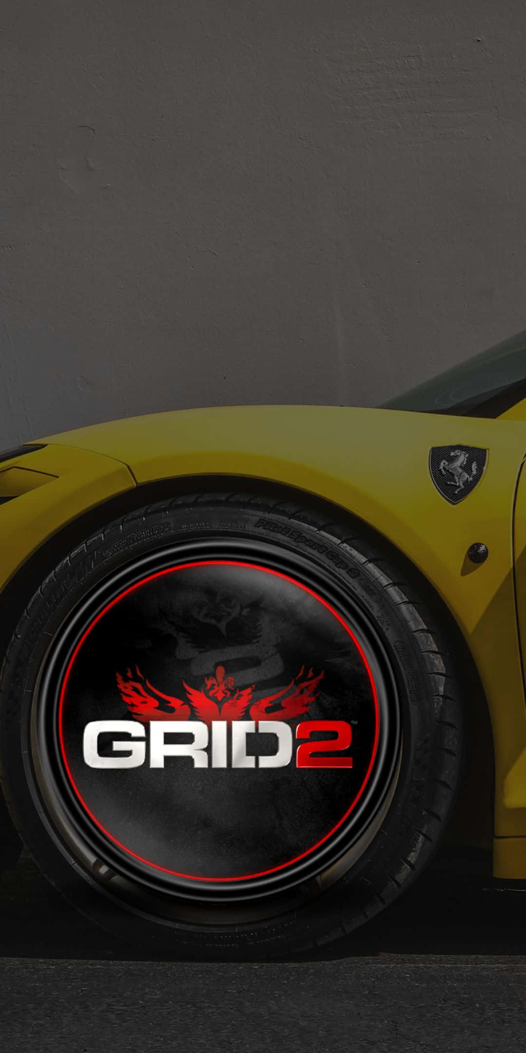 game 桌布 壁紙 — 黃色法拉利車輪特寫，黑色中心帶有GRID 2標誌和紅色火焰。