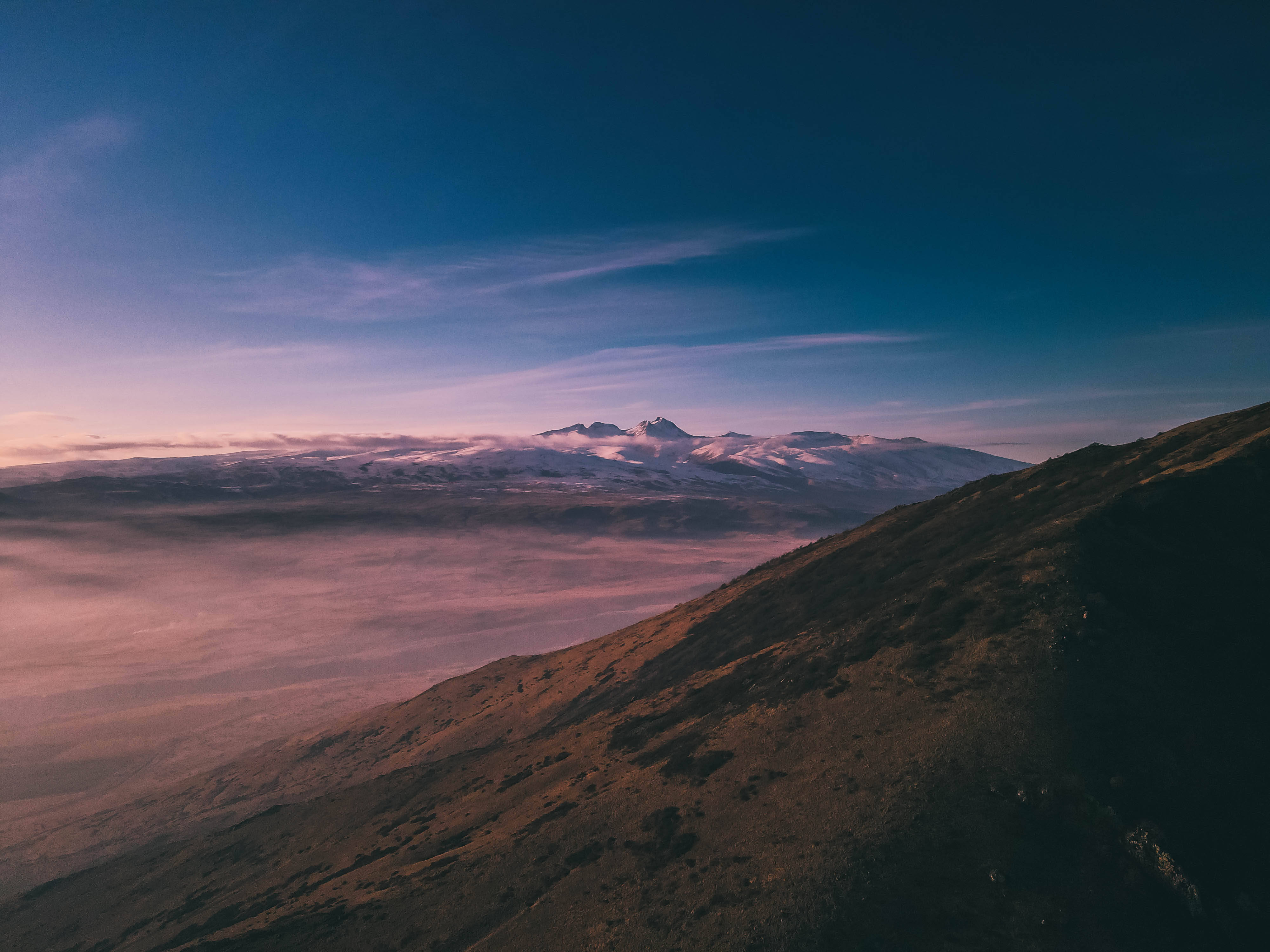 Armenia 桌布 壁紙 — 黎明時分，雄偉的山脈從粉紅色的雲海中升起，頭頂是深藍色的天空。