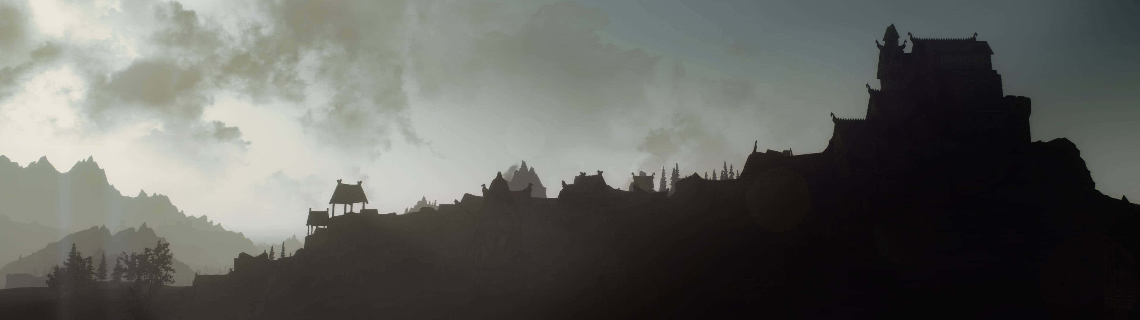 Minimalist Dual Monitor 桌布 壁紙 — 黎明時分，霧氣繚繞的山巒背景下，懸崖上矗立著一座古老城堡的剪影。