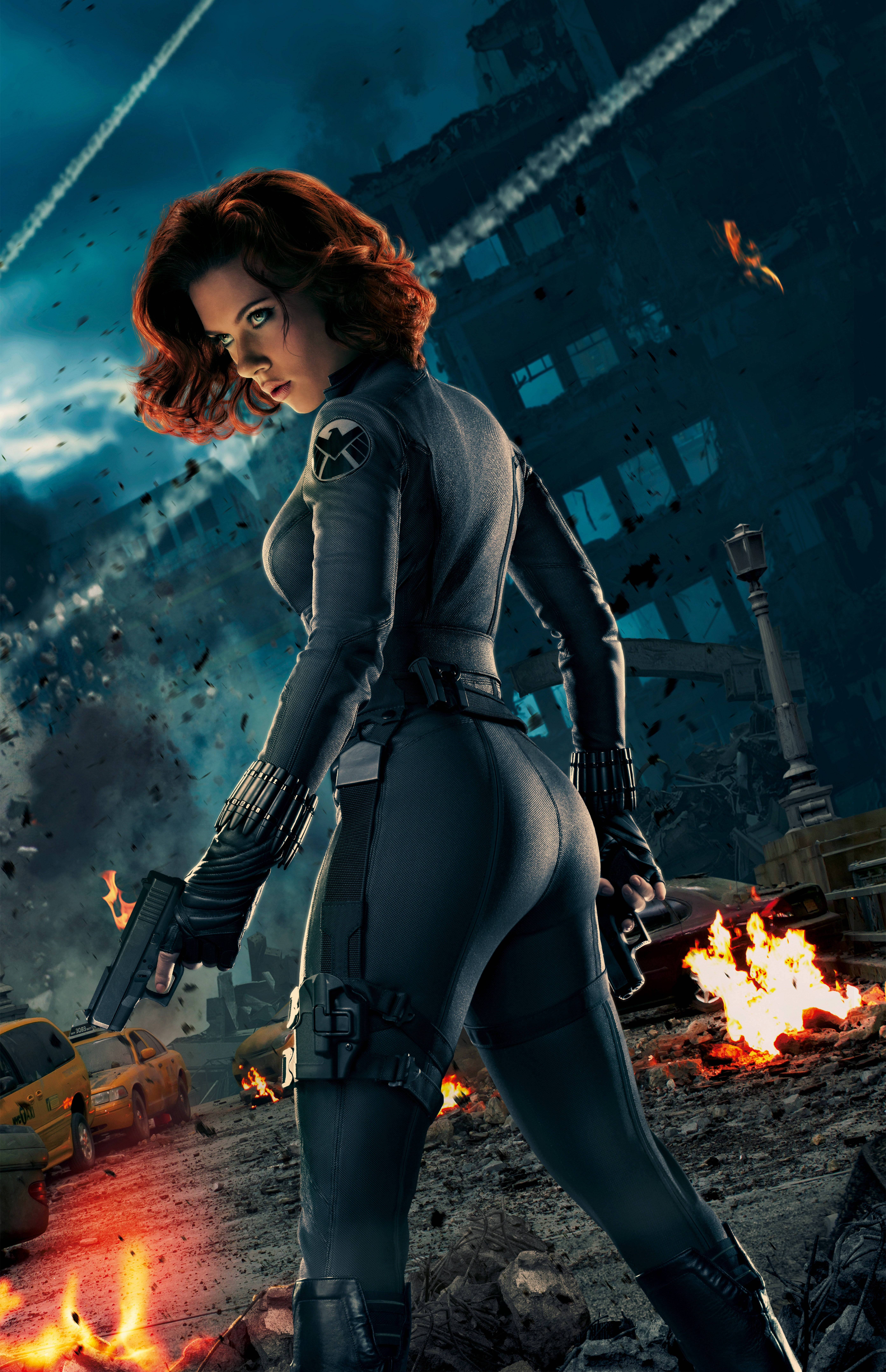 Black Widow 桌布 壁紙 — 黑寡婦在一片廢墟城市景觀中擺好姿勢，爆炸和碎片在她周圍飛舞。