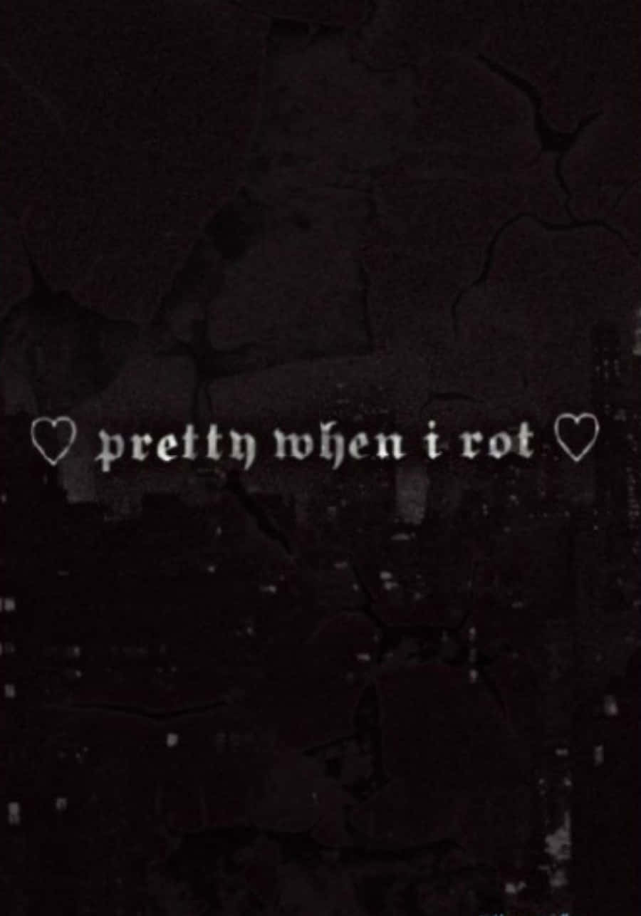 油漬搖滾 桌布 壁紙 — 黑暗裂縫牆壁，白色文字寫著 pretty when i rot，由心形框住。