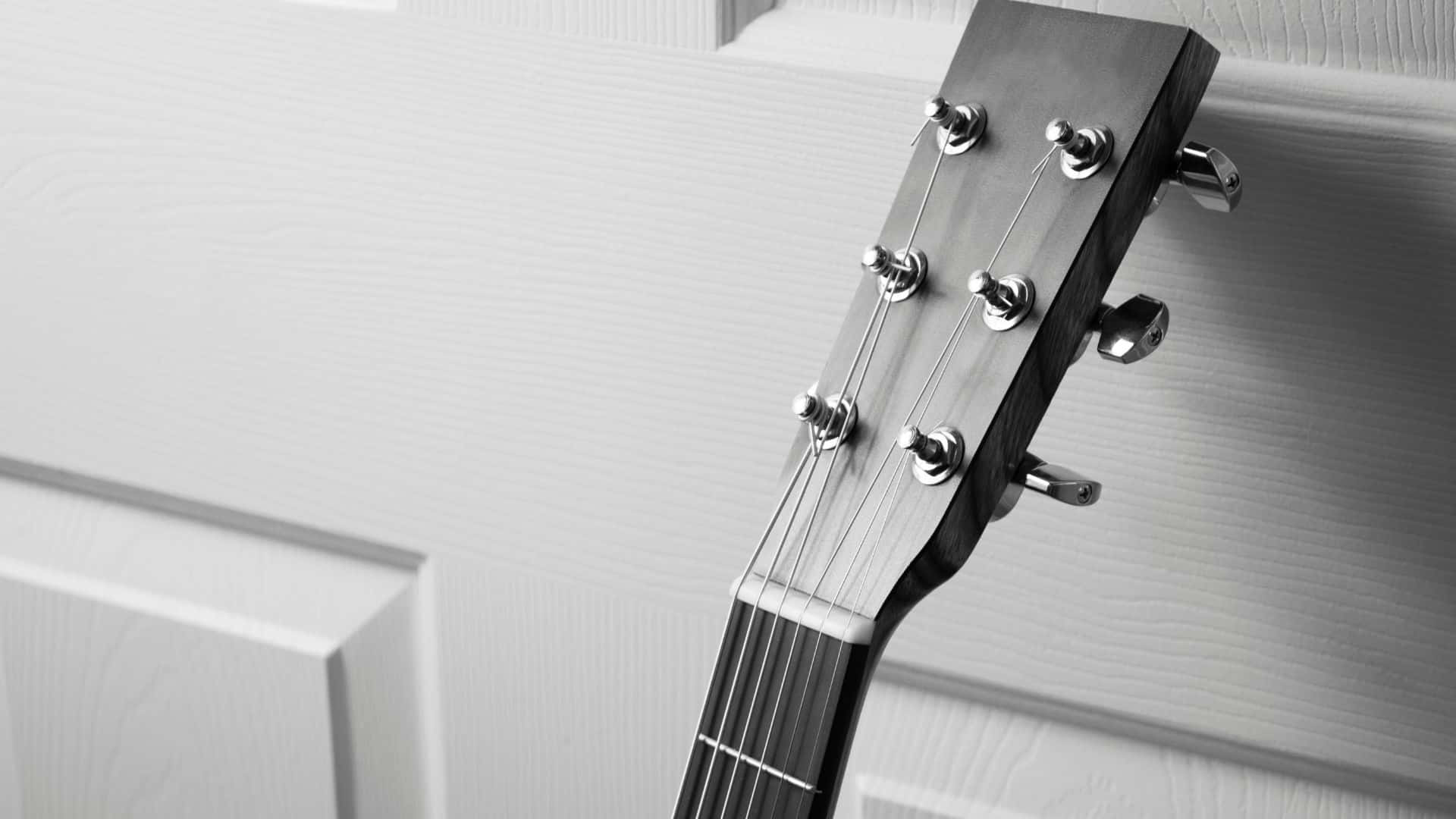 Black And White Guitar 桌布 壁紙 — 黑白單色中，白色鑲板門上的吉他頭部及調音栓特寫。