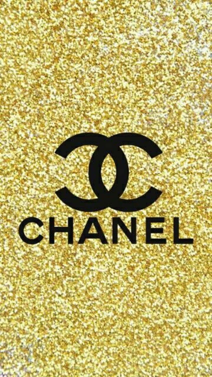 Chanel 桌布 壁紙 — 黑色 Chanel 標誌居中於閃爍的金色亮粉背景上。