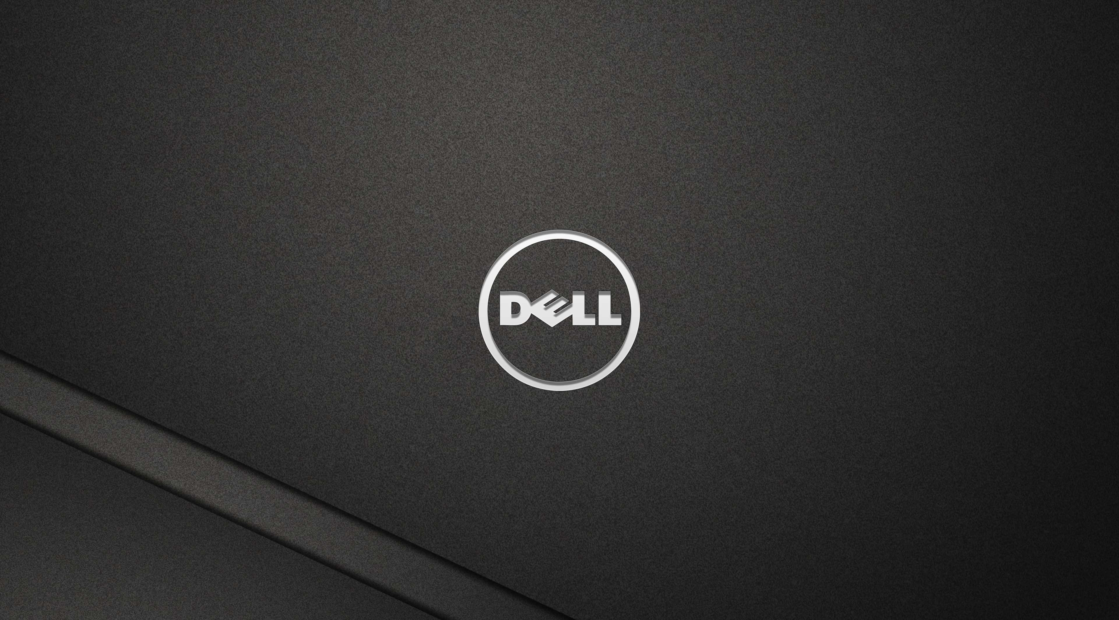 Dell 桌布 壁紙 — 黑色Dell筆記型電腦蓋的近距離特寫，銀色標誌居中於有紋理的霧面表面。