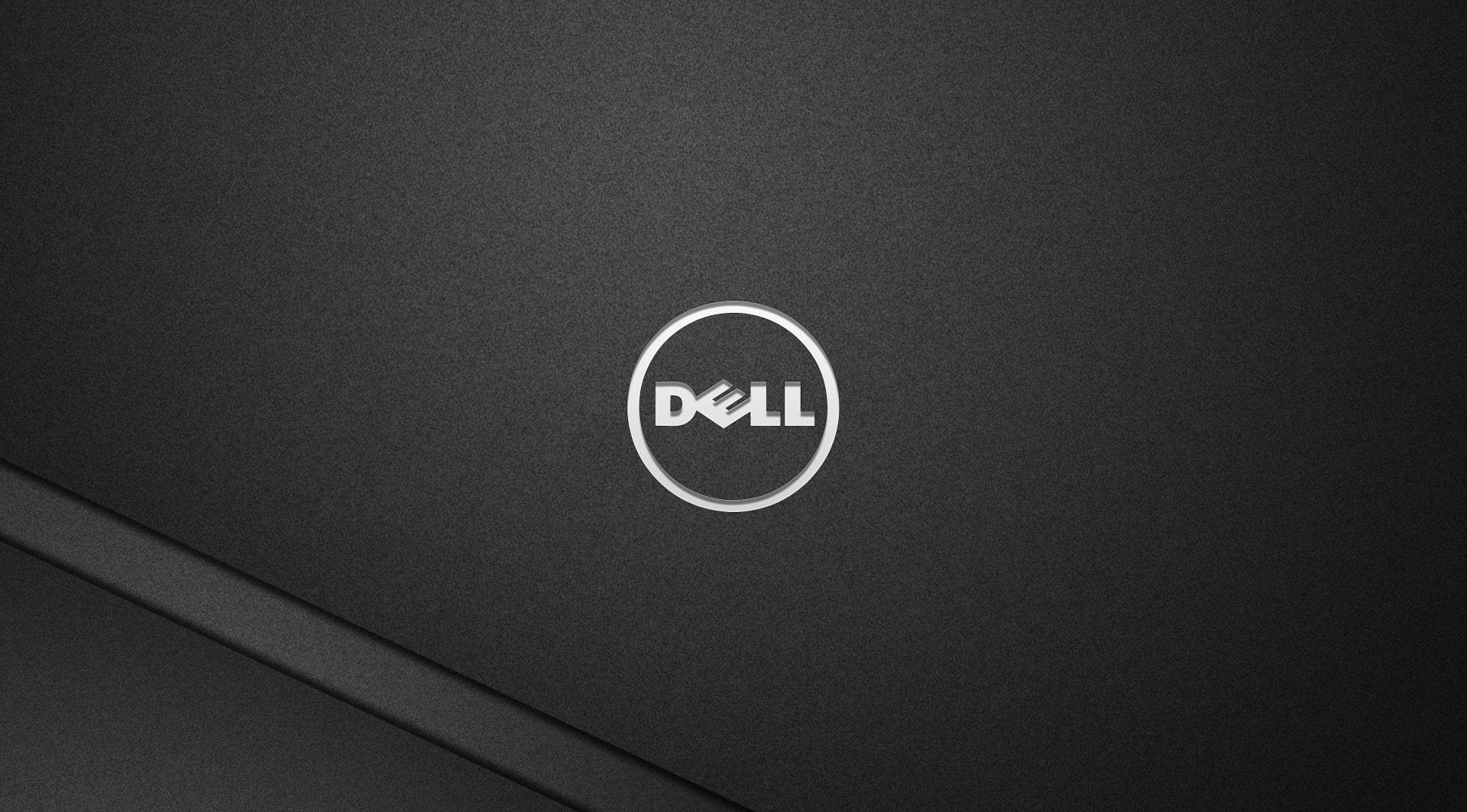 Dell Laptop 桌布 壁紙 — 黑色Dell筆記型電腦蓋的近距離特寫，銀色標誌居中於帶紋理的霧面表面上。