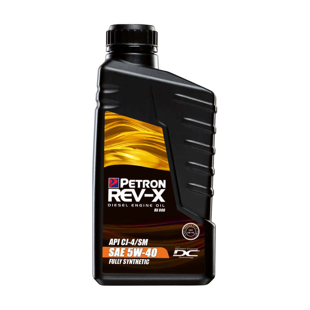引擎油 桌布 壁紙 — 黑色Petron Rev-X柴油引擎機油瓶，帶有金色液體漩渦標籤，白色背景。