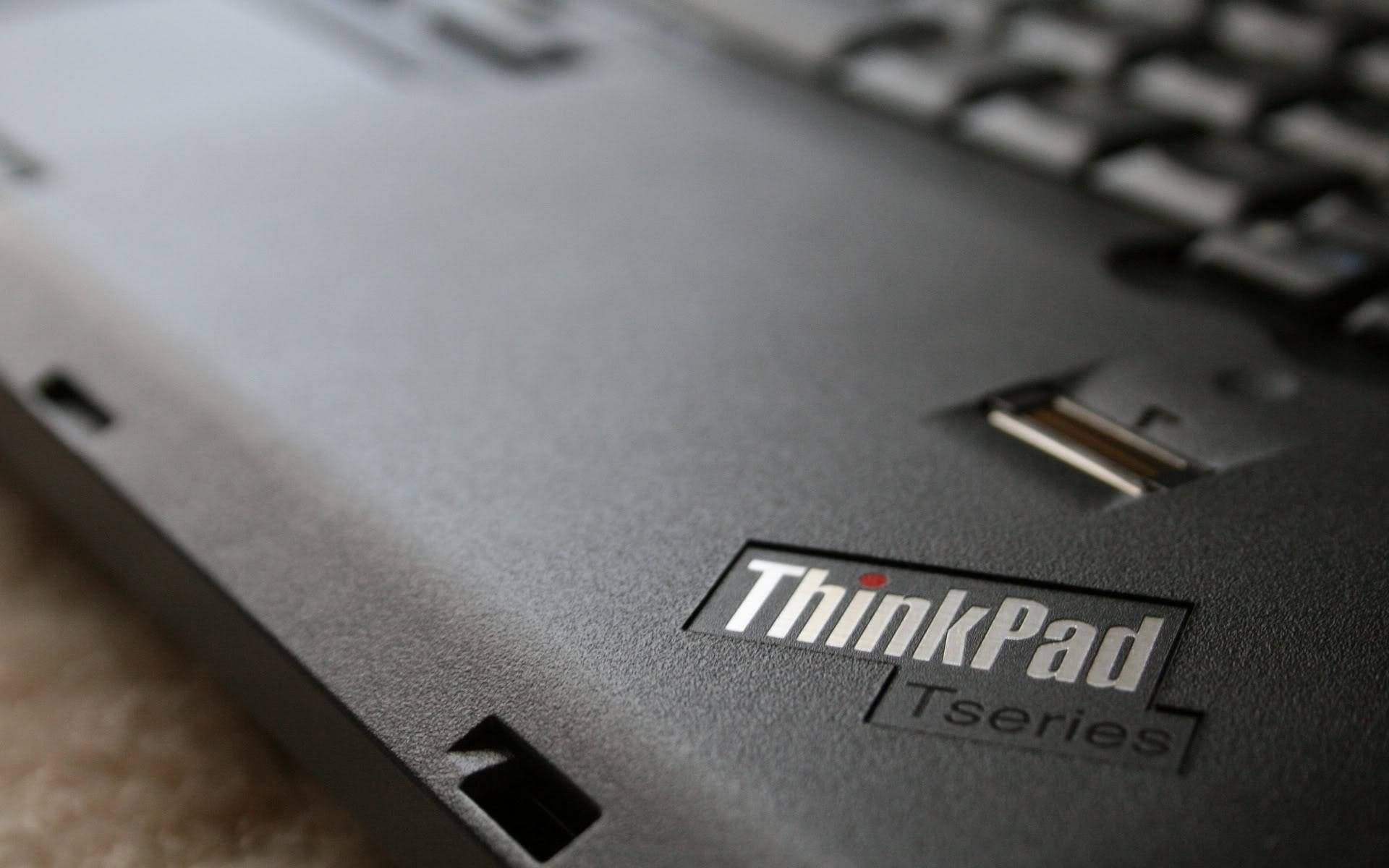 黑色ThinkPad Tseries筆記型電腦特寫，顯示標誌和USB連接埠。