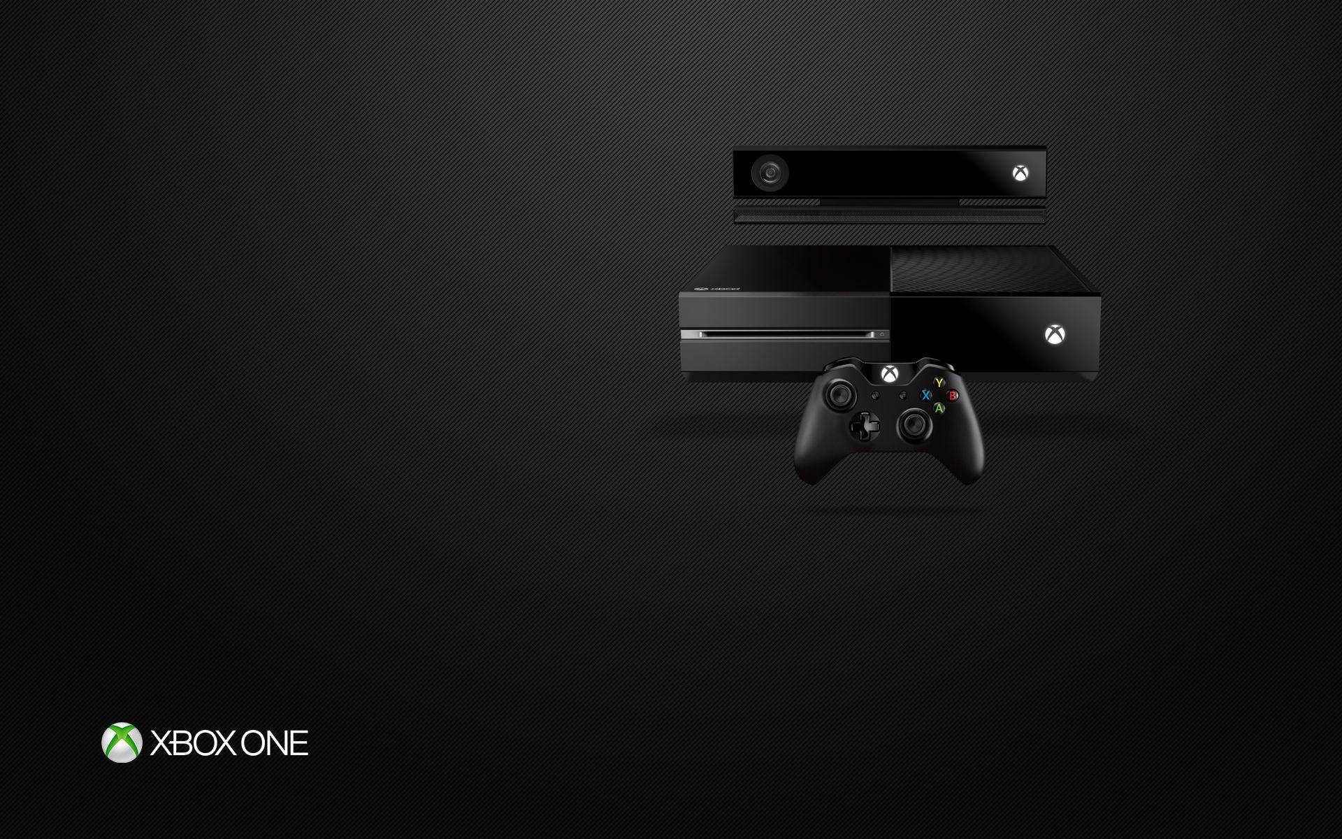 Xbox 桌布 壁紙 — 黑色Xbox One主機和控制器在帶有微妙燈光效果的深色紋理背景上展示。