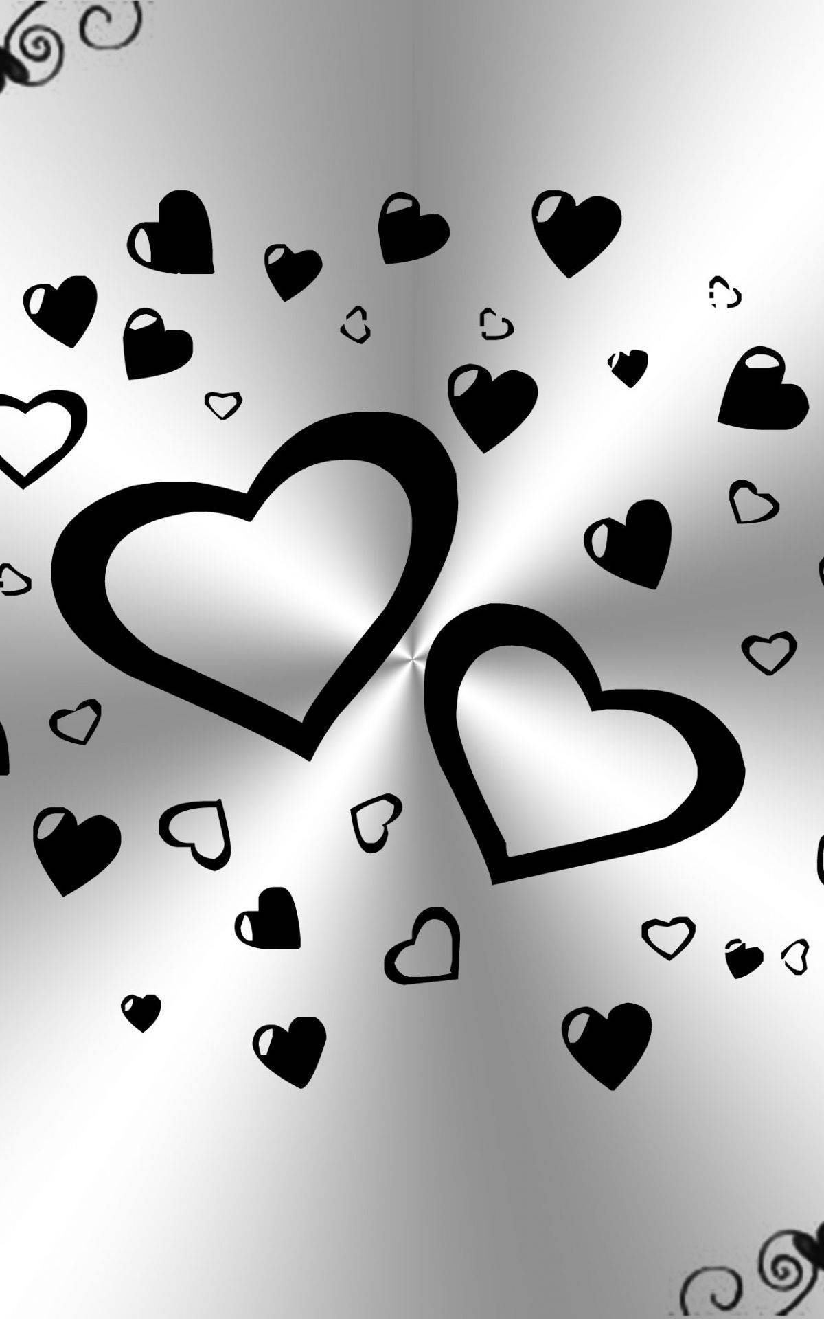Dark Heart 桌布 壁紙 — 黑色心形輪廓漂浮在帶有旋轉角落裝飾的閃亮銀色漸變背景上。