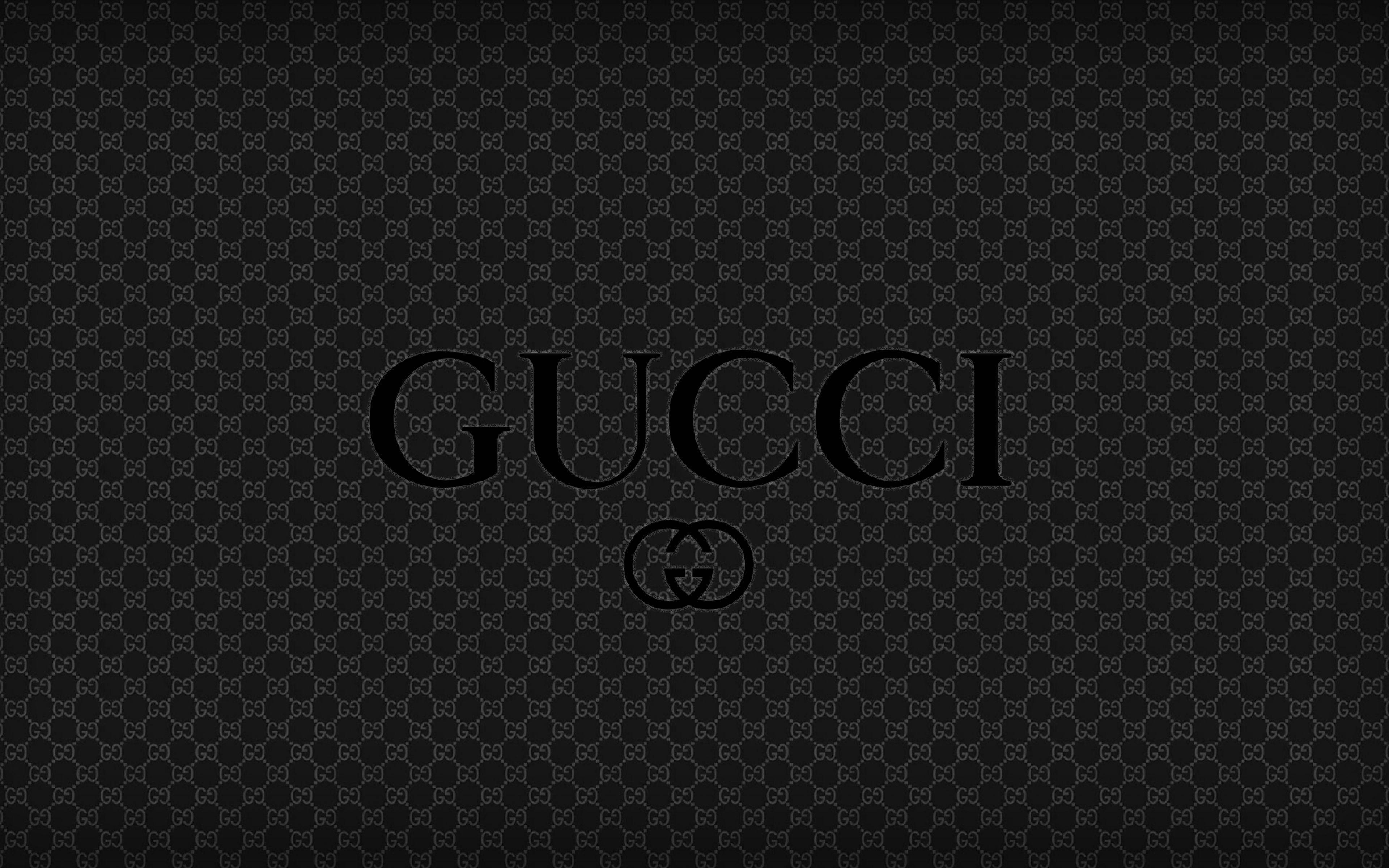Gucci 標誌在黑色字母組合背景上 — Gucci GIF 壁紙