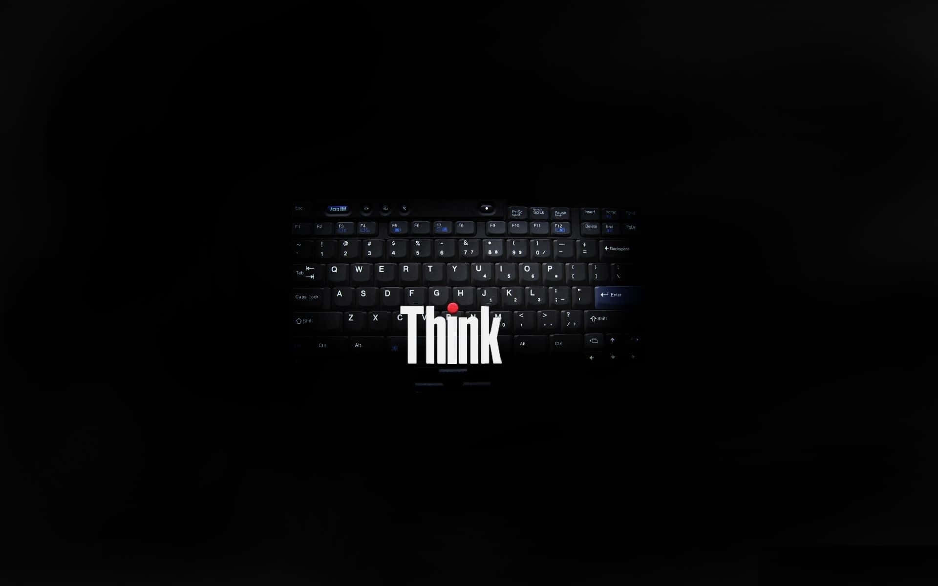 Lenovo 桌布 壁紙 — 黑色筆記型電腦鍵盤置於黑暗中，帶有發光白色「Think」標誌及空白鍵下方的紅點。