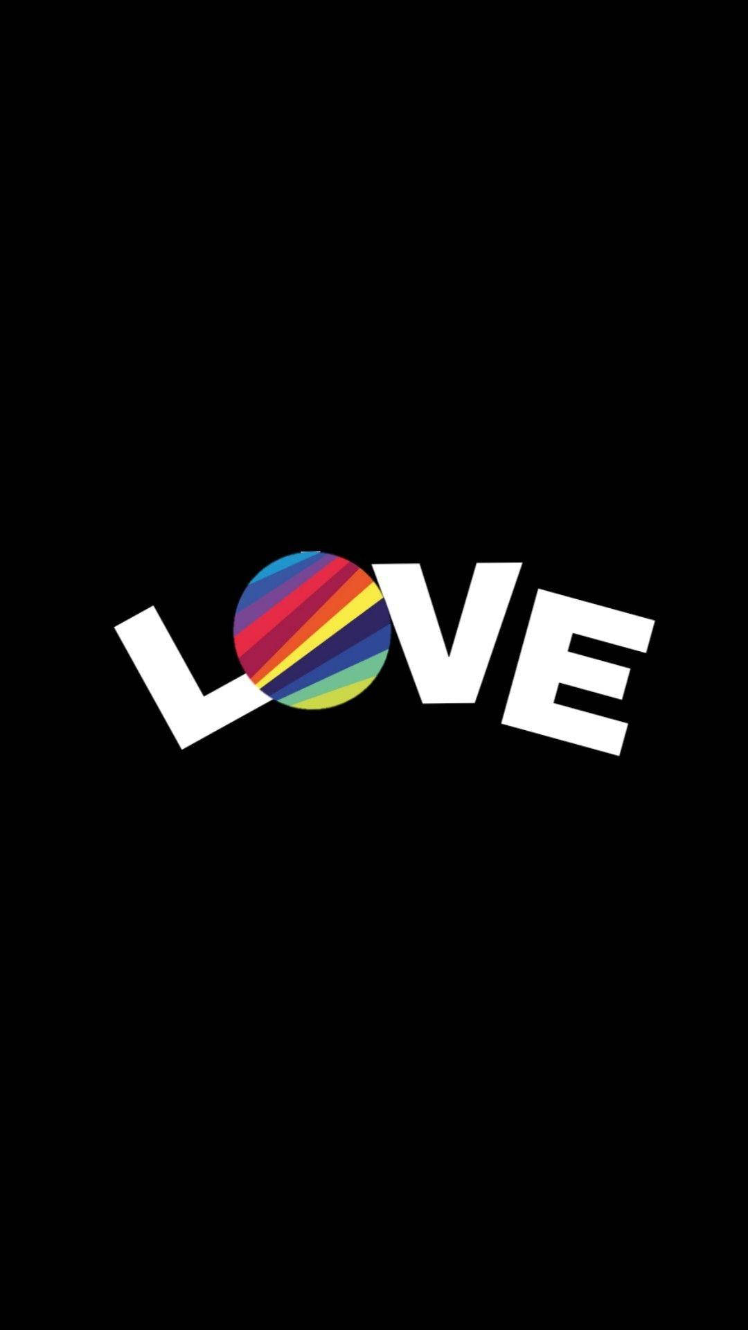 Now 桌布 壁紙 — 黑色背景上，粗體白色字母拼出「LOVE」一詞，其中 O 被一個充滿活力的彩虹條紋圓圈取代。