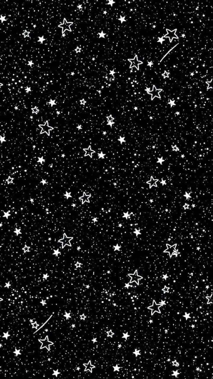 桌布 壁紙 — 黑色背景上佈滿白色輪廓星星和流星條紋，營造出宇宙夜空圖案。