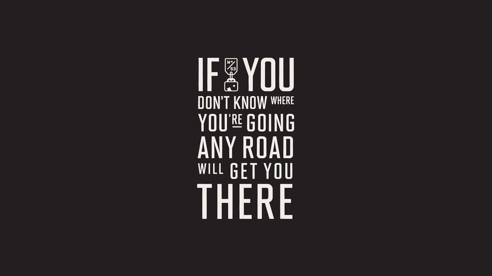 眼鏡蛇道館 桌布 壁紙 — 黑色背景上粗體白色文字寫著「IF YOU DON'T KNOW WHERE YOU'RE GOING ANY ROAD WILL GET YOU THERE」，並以行李箱圖示取代「YOU」中的「O」。