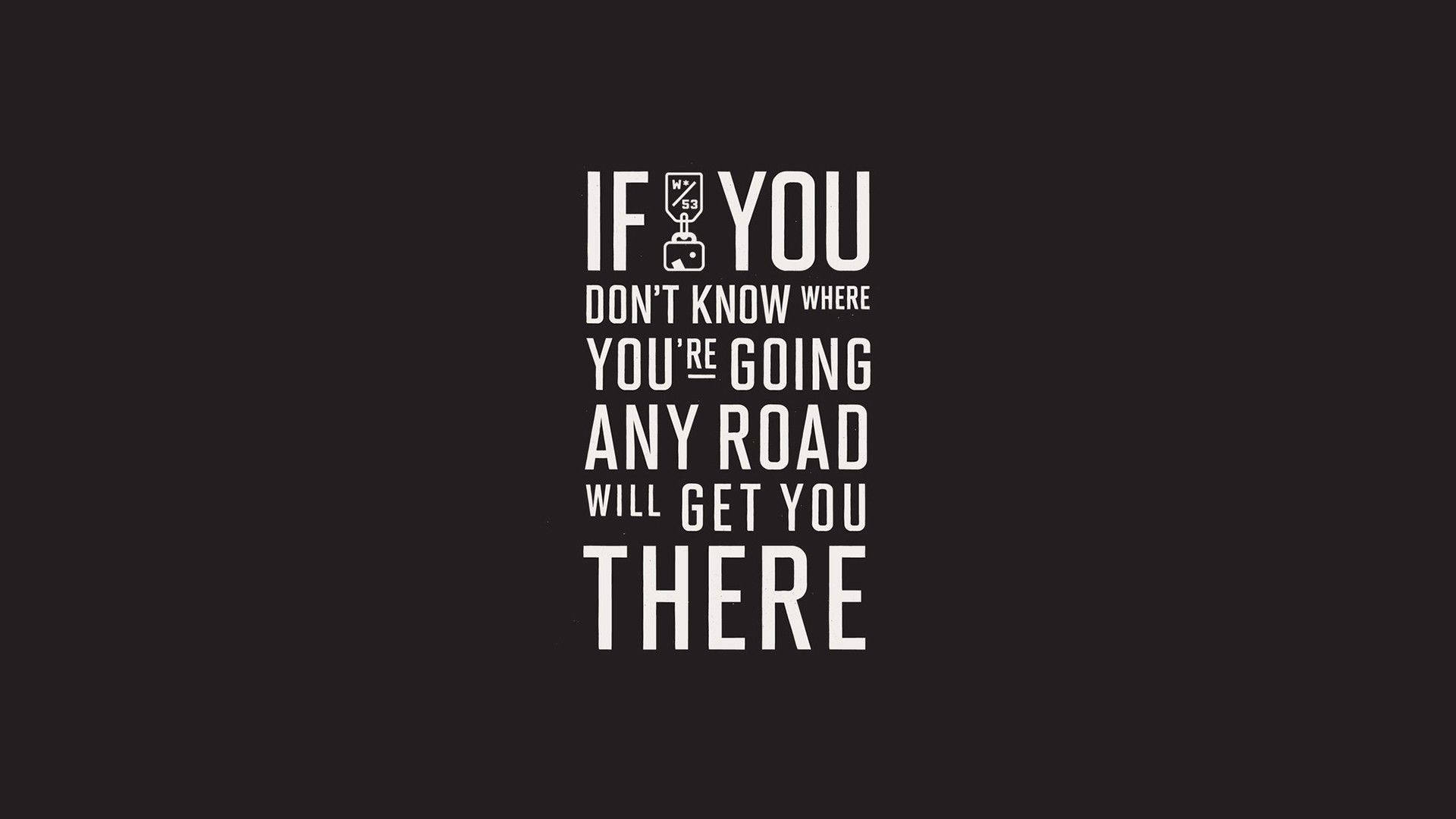 wonderland 桌布 壁紙 — 黑色背景上粗體白色文字寫著「IF YOU DON'T KNOW WHERE YOU'RE GOING ANY ROAD WILL GET YOU THERE」，並有一個行李箱圖示取代了「I」。