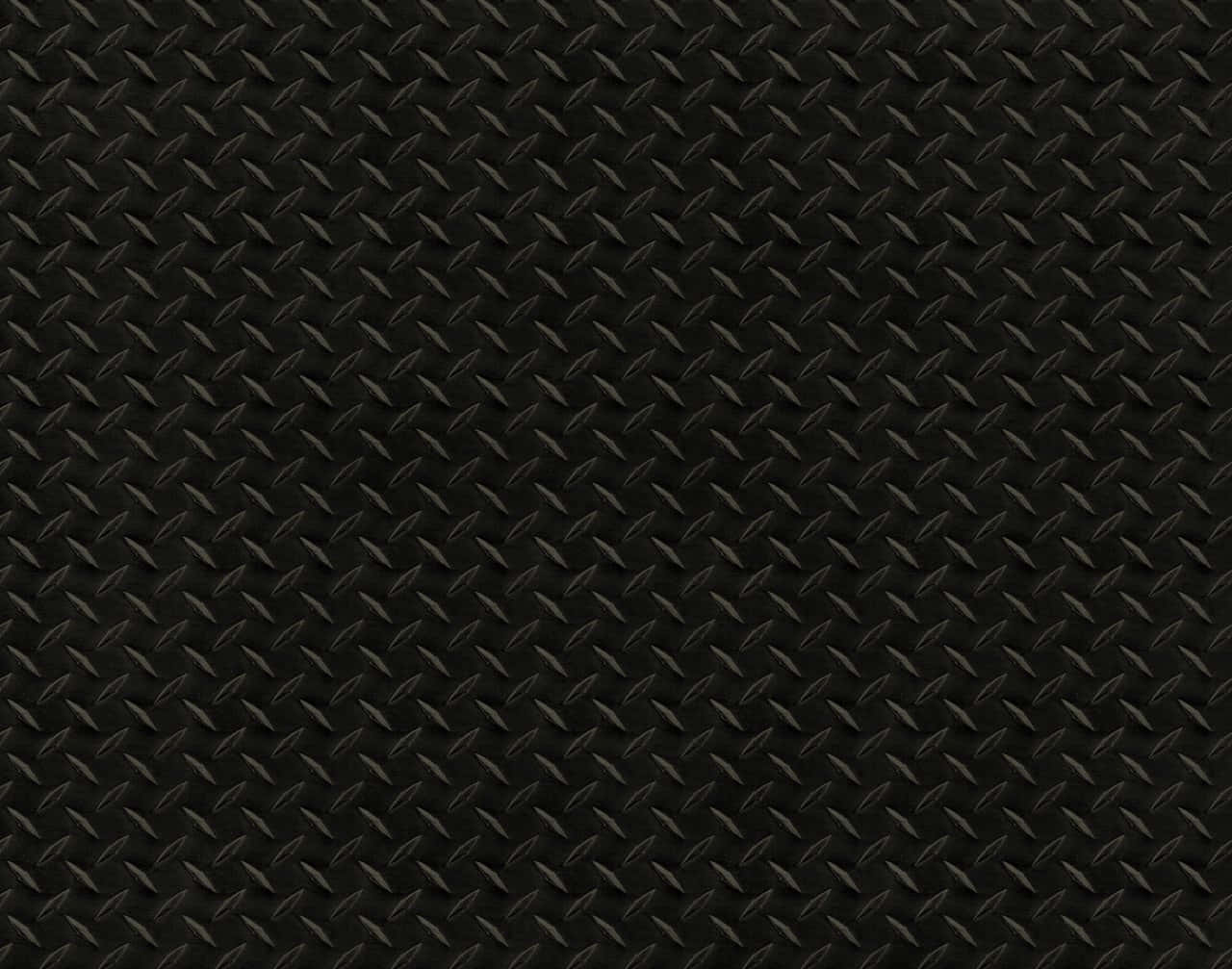 Diamond Plate 桌布 壁紙 — 黑色菱形金屬板表面的特寫，帶有重複的凸起菱形圖案和微妙的灰色高光。
