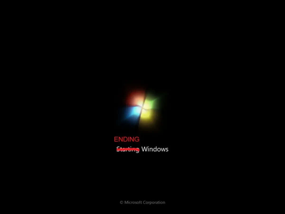 Windows 7 桌布 壁紙 — 黑色螢幕顯示Windows標誌，以紅、橙、黃、綠、藍色發光，並顯示文字「結束 正在啟動 Windows」。