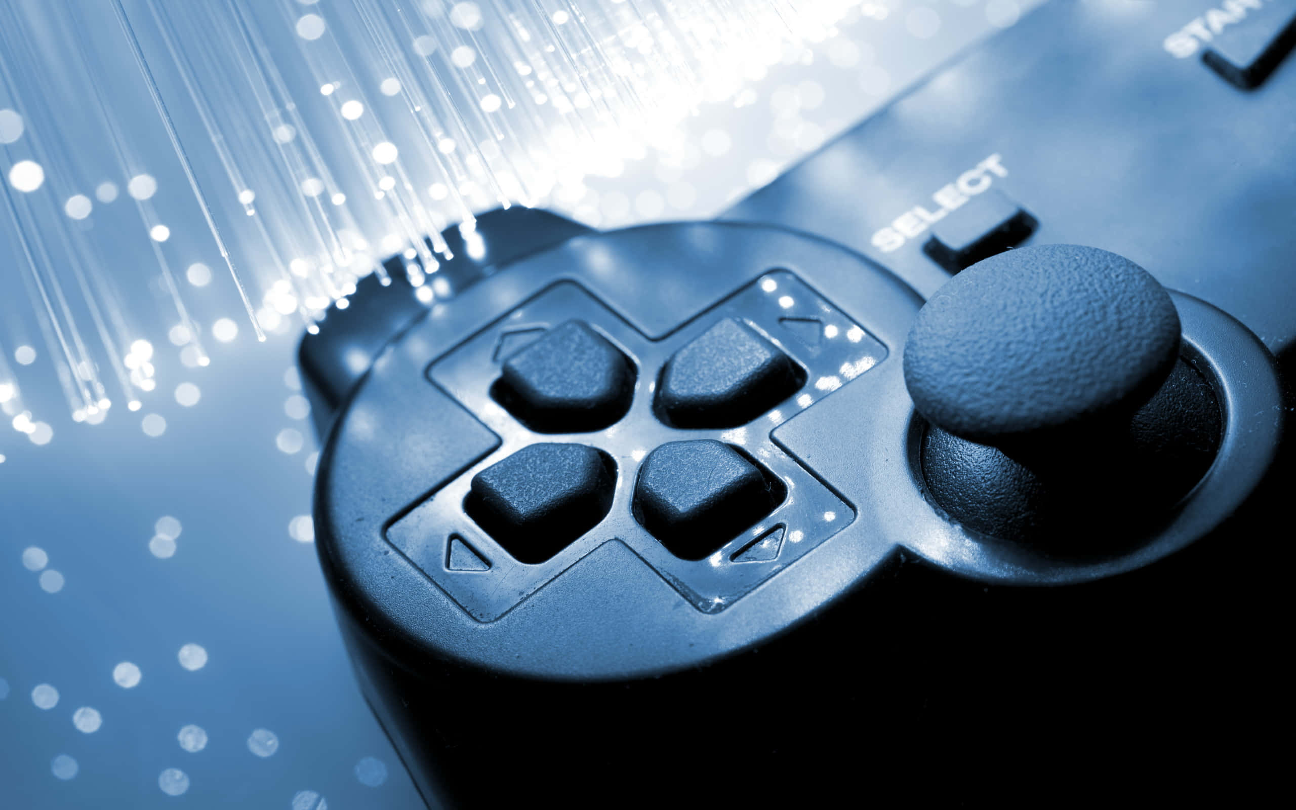Remote 桌布 壁紙 — 黑色遊戲控制器特寫，帶有冷藍色調的發光光纖線。