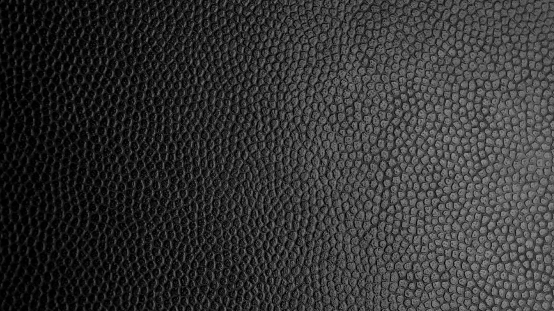 Leather 桌布 壁紙 — 黑色鵝卵石皮革紋理的近距離特寫，帶有微妙的漸變燈光。