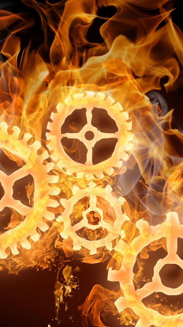 iPhone Fire 桌布 壁紙 — 齒輪在深色背景下於鮮豔的橙色火焰中劇烈燃燒。