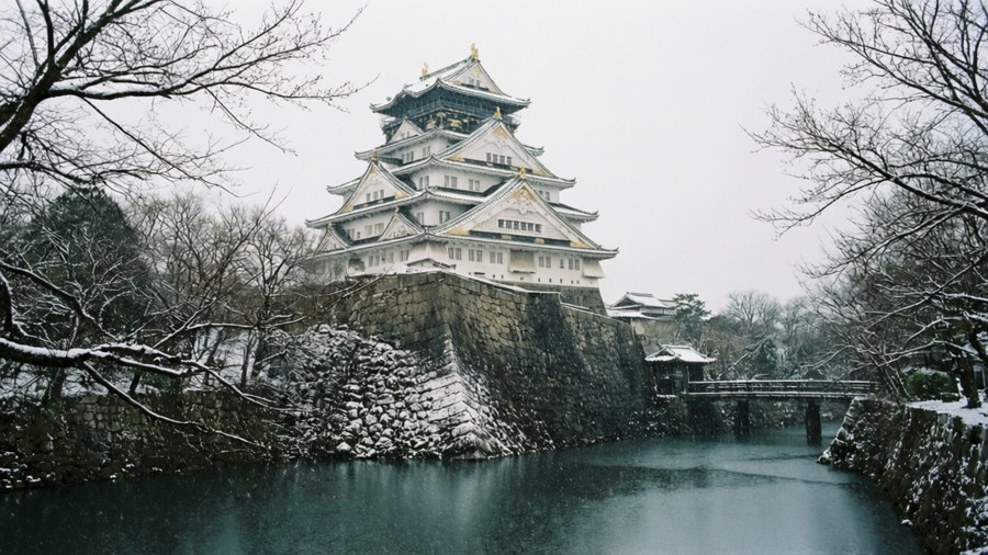 Osaka Castle lightly dusted with snow in serene winter scene