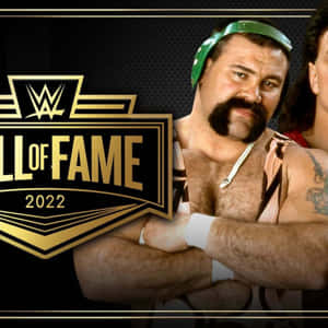 2022年WWE名人堂入選者，戴著綠色頭帶，手臂有刺青，自信地擺姿勢。 — WWE GIF 壁紙
