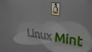 Linux Mint 標誌和企鵝吉祥物的 3D 渲染在灰色牆壁上。 — 企鵝 GIF 壁紙