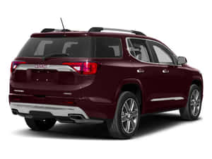 在攝影棚環境中從車尾四分之三角度觀看的栗色GMC Acadia SUV。 — 凱迪拉克 壁紙