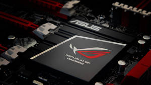 ASUS ROG 遊戲主機板特寫，帶有紅色和黑色組件。 — 玩家共和國 壁紙