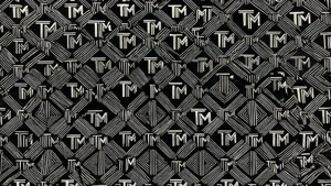 黑白幾何壁紙，帶有重複的風格化TM標誌。