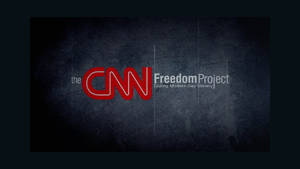 CNN Freedom Project 標誌在裂紋灰色牆壁背景上。