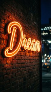 夜晚城市中，磚牆上寫著Dream的霓虹燈牌。