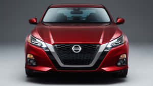 紅色日產轎車正面視圖在攝影棚 — 日產 壁紙