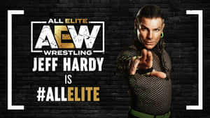 摔角手 Jeff Hardy 身穿黑色網狀服裝，在磚牆背景上帶有 AEW 標誌指向前方。 — 湯姆·哈迪 壁紙