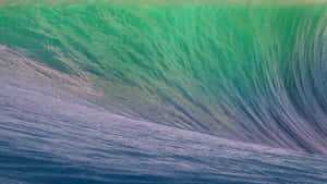 高聳的海浪捲成一個綠色桶，下面有深藍色的水。 — 波浪 壁紙