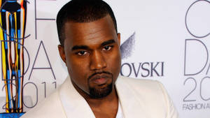Kanye West 在2011年時尚頒獎典禮上身穿白色西裝，表情嚴肅。 — 肯伊·威斯特 壁紙