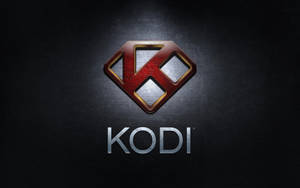 深色背景上帶有紅、金、銀金屬設計的 Kodi 媒體播放器標誌。 — 科迪 壁紙