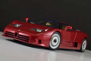 紅色Bugatti EB110模型車在白色表面上，背景為深色。 — MacBook Pro M3 壁紙
